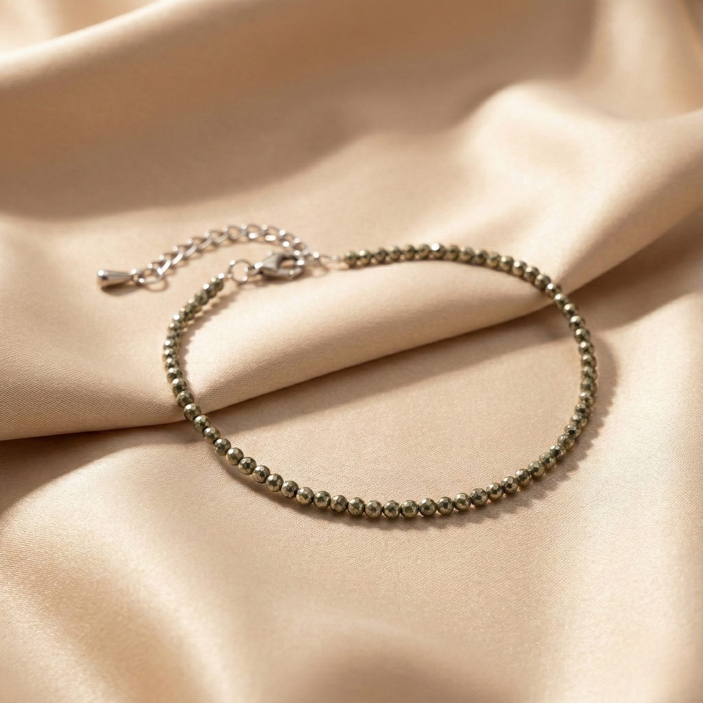 A pair of natural golden Pyrite beaded anklets designed for wealth manifestation and spiritual grounding