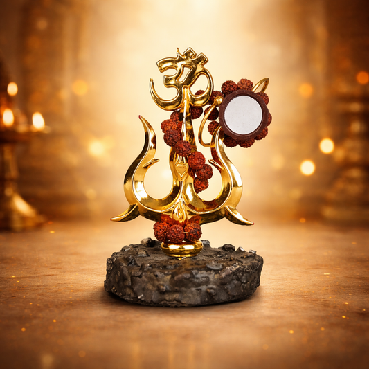 A handcrafted Shiva Shakti Trishul made of polished brass, featuring a central spear flanked by two curved outer blades. A small wooden Damru is tied to the shaft with a sacred red and yellow thread, symbolizing the balance of creation and destruction.