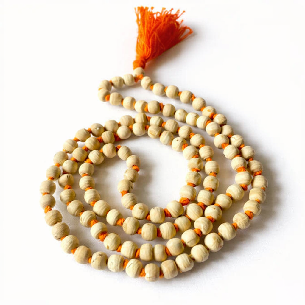A handcrafted natural Tulsi Mala made from authentic light-brown basil wood beads, strung together with a traditional orange tassel. The beads show natural wood grain textures, symbolizing purity and devotion.