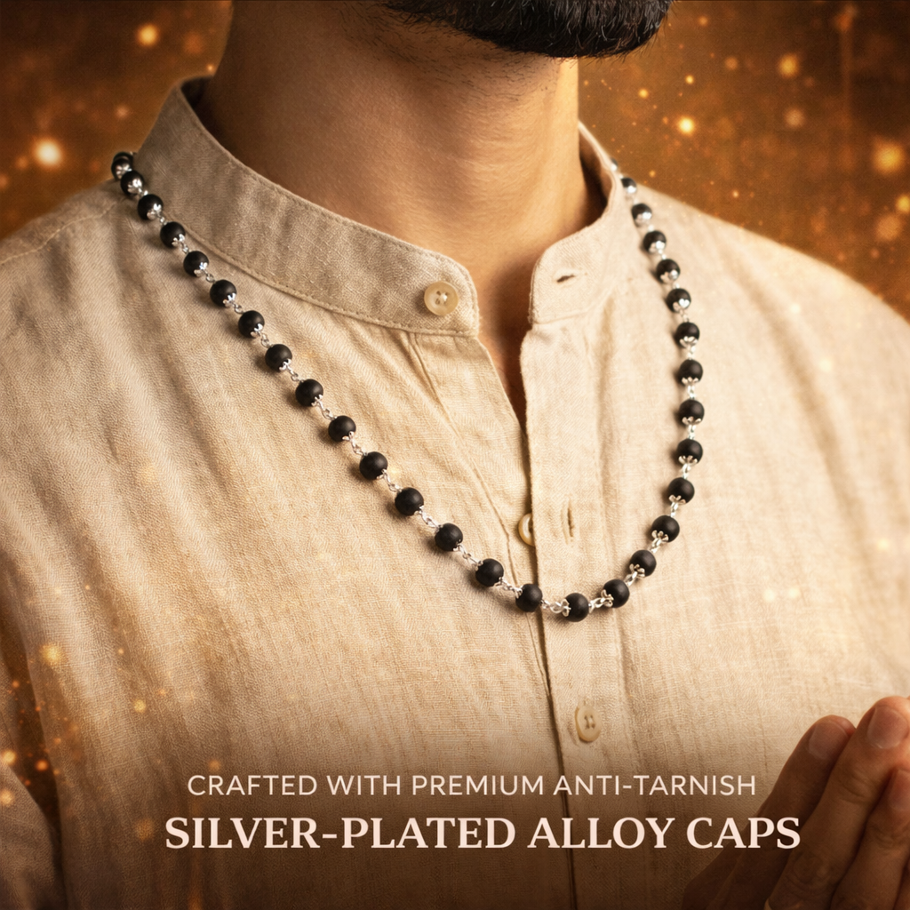 A premium Karungali Mala featuring 108 authentic black ebony wood beads, each meticulously capped with polished pure silver. The dark, matte texture of the wood contrasts beautifully with the gleaming silver caps, finished with a silver-capped Guru bead and a traditional black tassel.