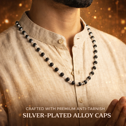 A premium Karungali Mala featuring 108 authentic black ebony wood beads, each meticulously capped with polished pure silver. The dark, matte texture of the wood contrasts beautifully with the gleaming silver caps, finished with a silver-capped Guru bead and a traditional black tassel.