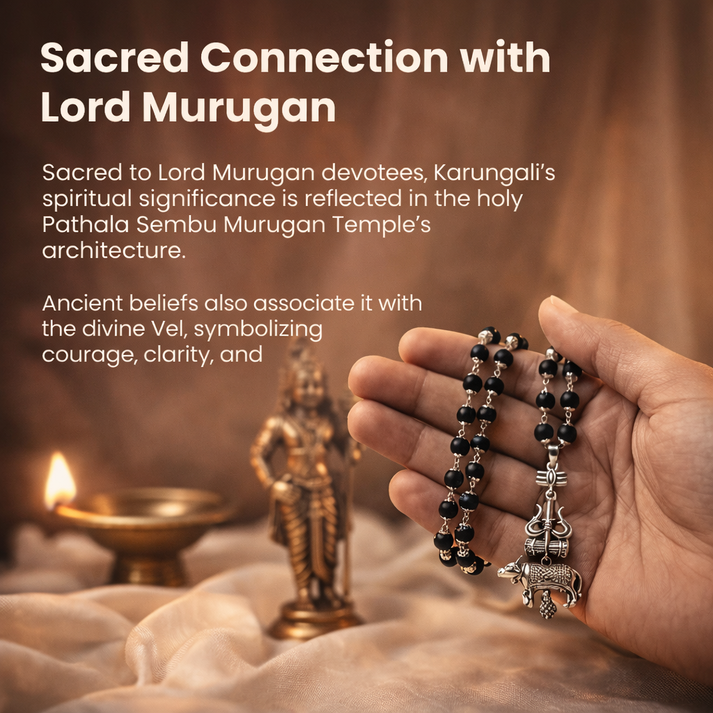 A sacred Shiv Raksha mala featuring 108 polished black Karungali (Ebony wood) beads. The mala is adorned with a detailed metallic pendant featuring Lord Shiva’s Trishul and Nandi the bull, symbolizing ultimate protection and devotion.