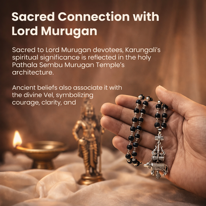 A sacred Shiv Raksha mala featuring 108 polished black Karungali (Ebony wood) beads. The mala is adorned with a detailed metallic pendant featuring Lord Shiva’s Trishul and Nandi the bull, symbolizing ultimate protection and devotion.