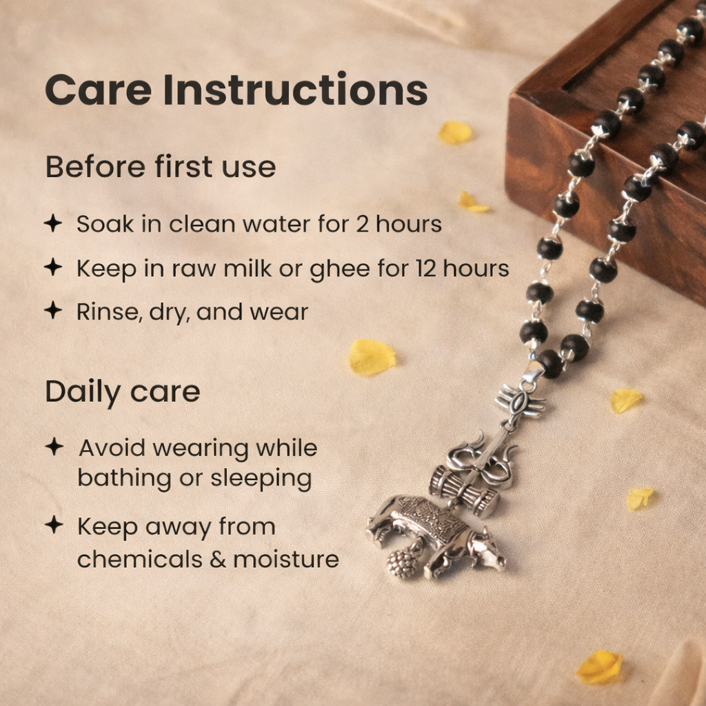 A sacred Shiv Raksha mala featuring 108 polished black Karungali (Ebony wood) beads. The mala is adorned with a detailed metallic pendant featuring Lord Shiva’s Trishul and Nandi the bull, symbolizing ultimate protection and devotion.