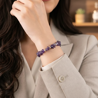 A stretchable chip stone bracelet made of natural purple Amethyst. The image shows numerous small, irregularly shaped and polished amethyst chips in varying shades of lavender and deep violet, strung on a durable transparent elastic cord for a comfortable fit.