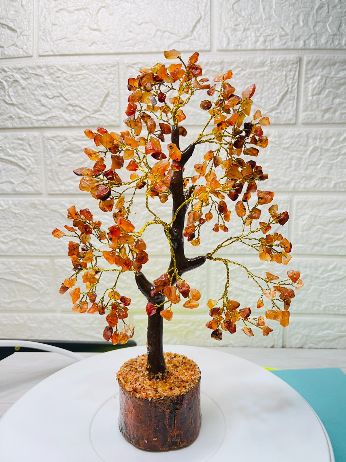 Handcrafted Carnelian Crystal Tree with golden wire branches and natural orange carnelian chips on a wooden base for confidence, motivation, and positive energy.