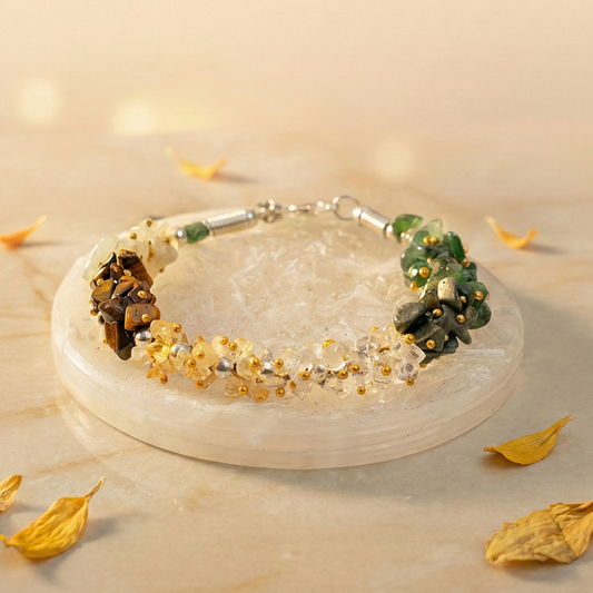Dhan Yog multi-crystal chips bracelet for wealth manifestation resting on a raw white Selenite charging plate.